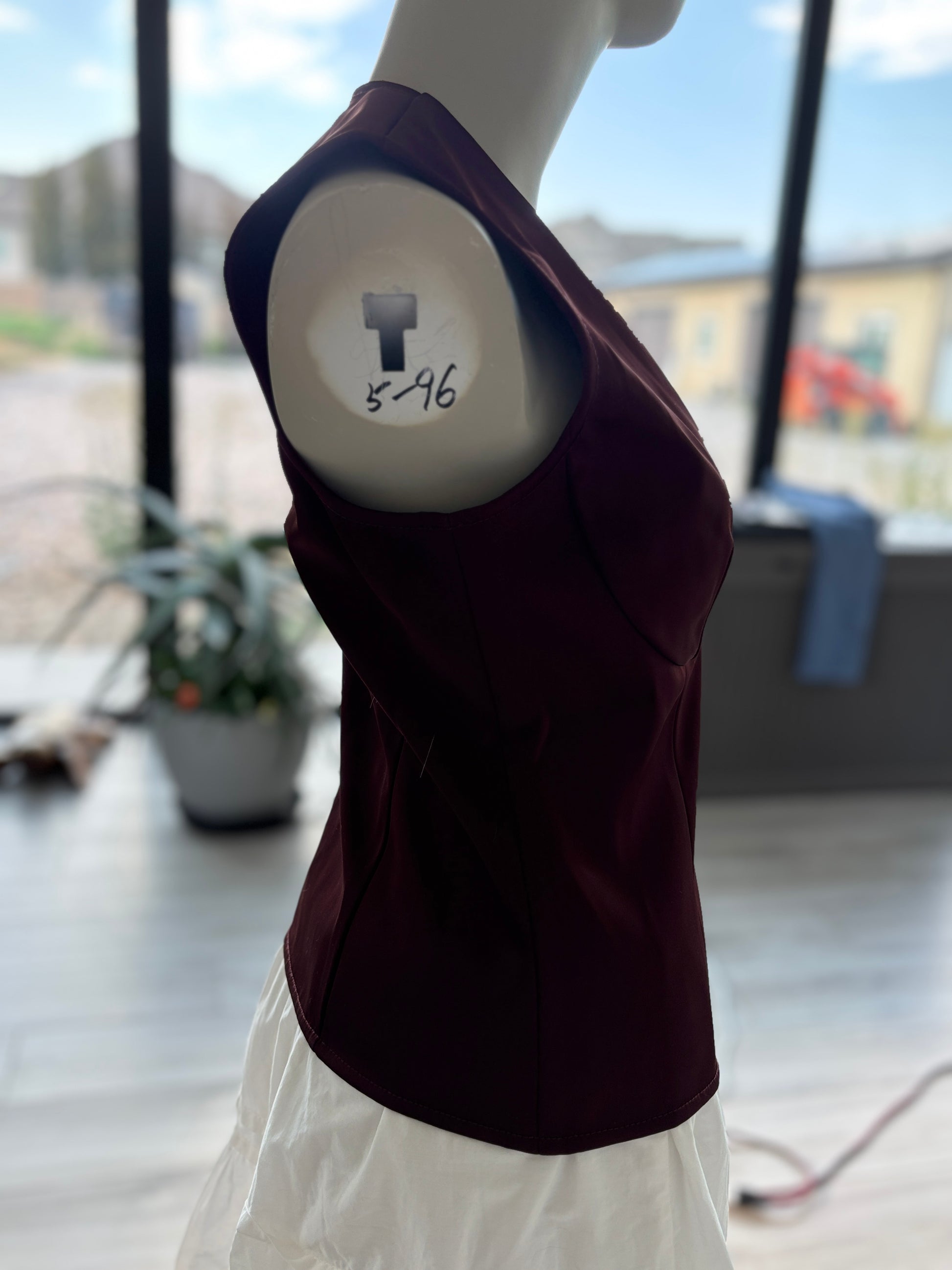 Anthropologie oxblood sleeveless evening top with lustrous fabric, defined bust cups, and an elegant fitted shape.