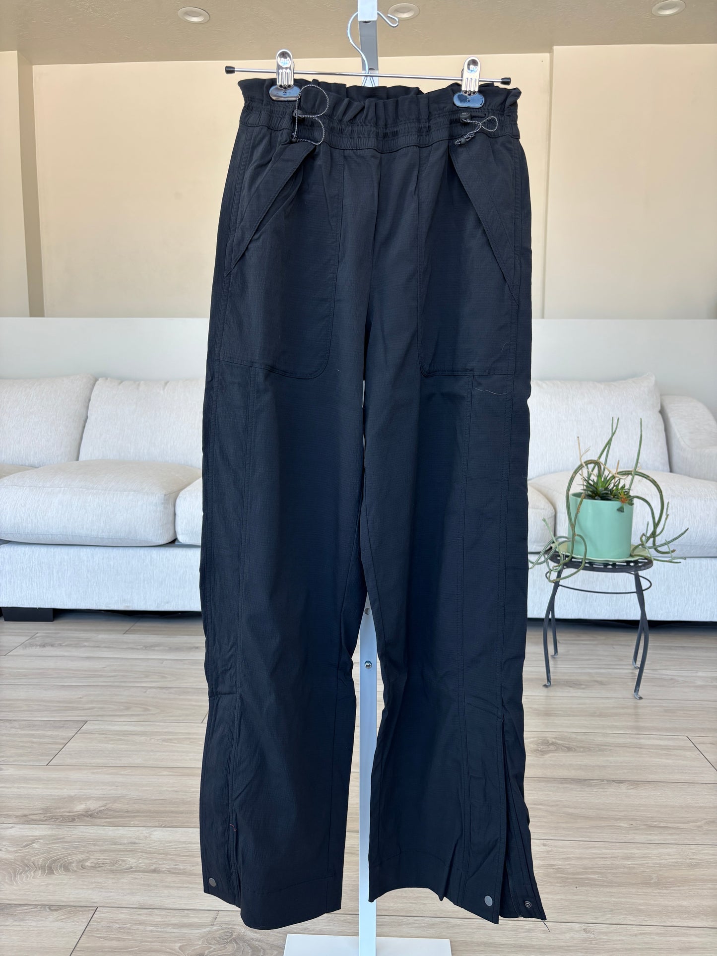 Athleta black travel pants with double cinch waist and 10 inch ankle zip vents from Adored Again boutique