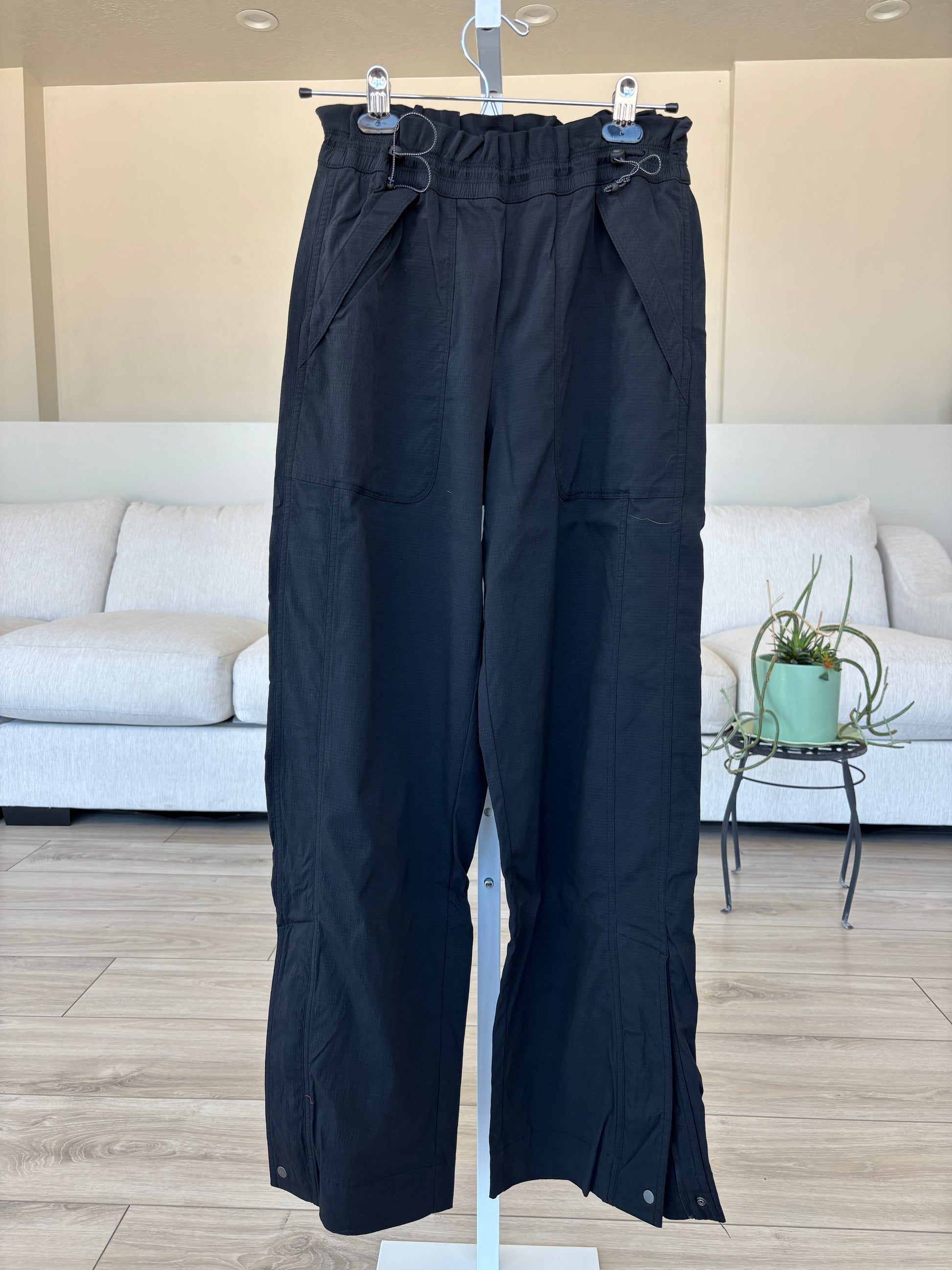 Athleta black travel pants with double cinch waist and 10 inch ankle zip vents from Adored Again boutique