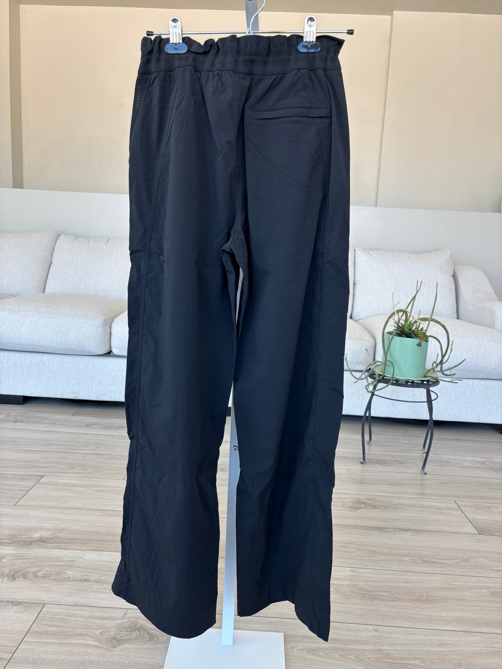 Athleta size 6 black straight leg pants with adjustable waist and zipper ankle vents from Adored Again boutique