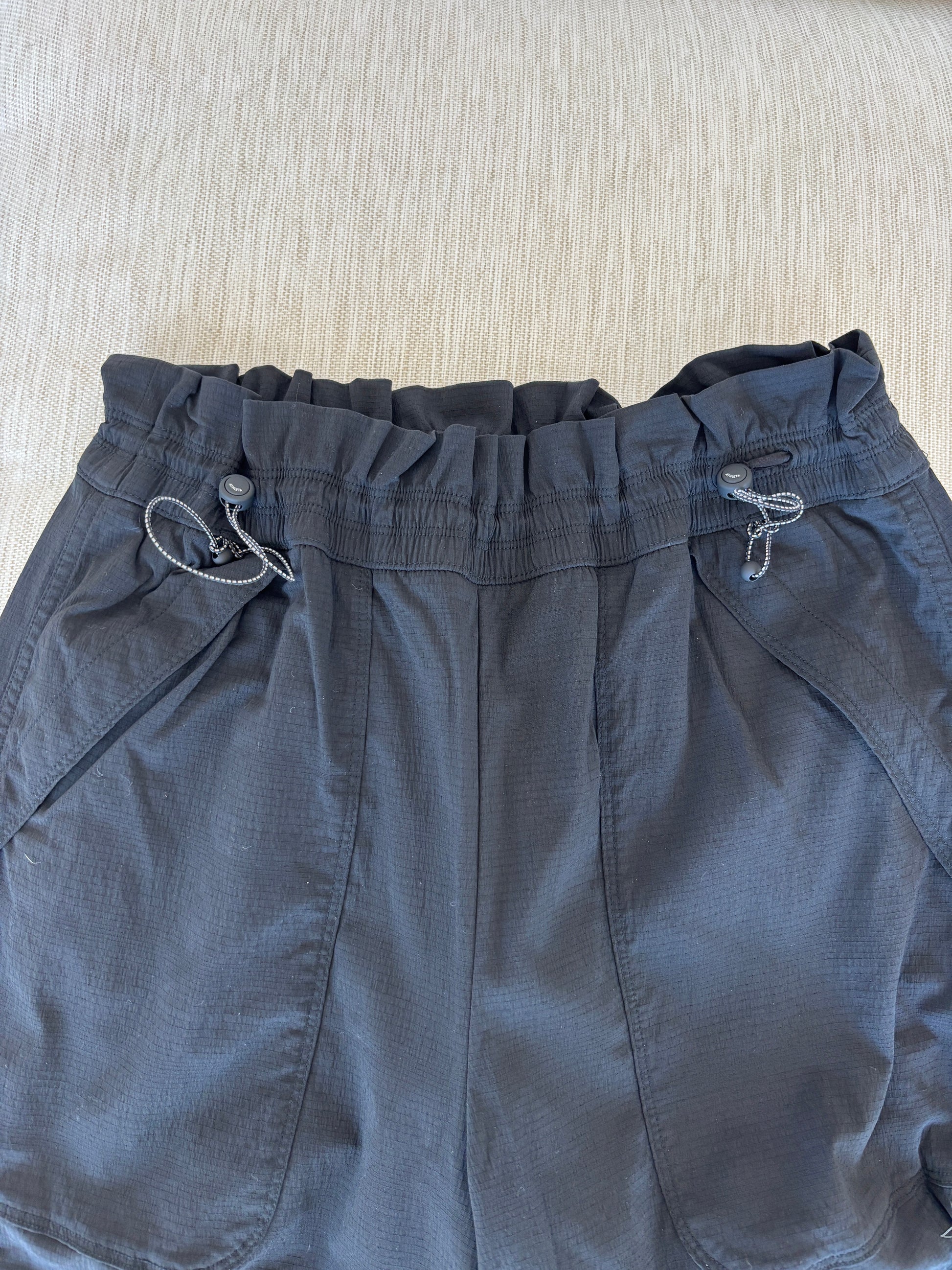 Athleta black nylon spandex pants size 6 styled with sneakers for a polished sporty look from Adored Again boutique