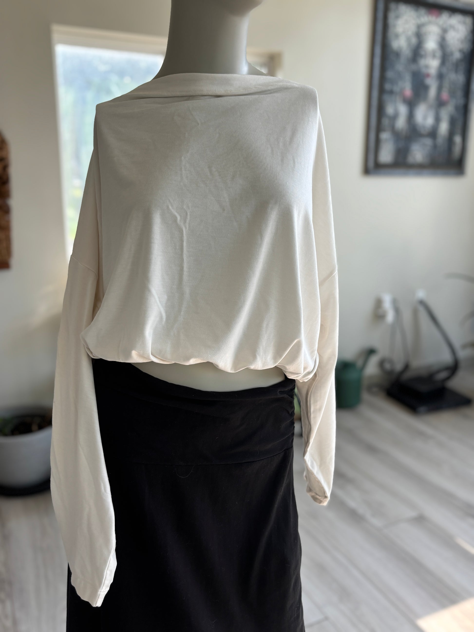 Athleta ivory long-sleeve top with a relaxed body, adjustable gathered bubble hem, and side tassel ties.
