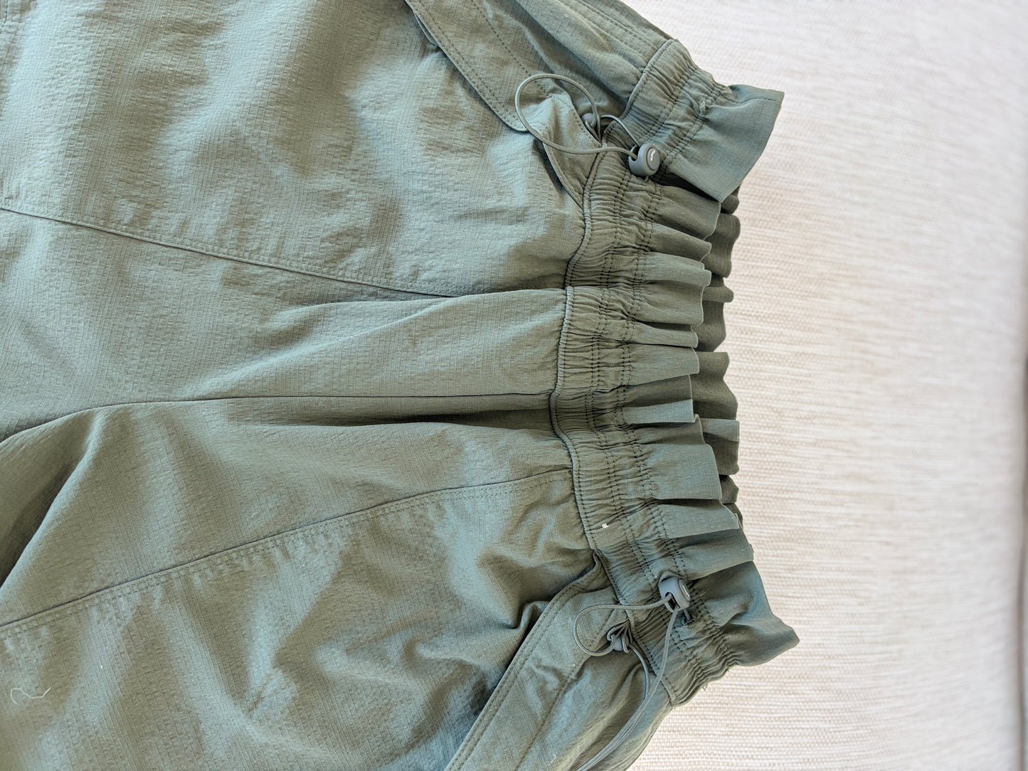 Athleta size 6 dark olive straight leg pants with adjustable waist and zipper ankle vents from Adored Again boutique