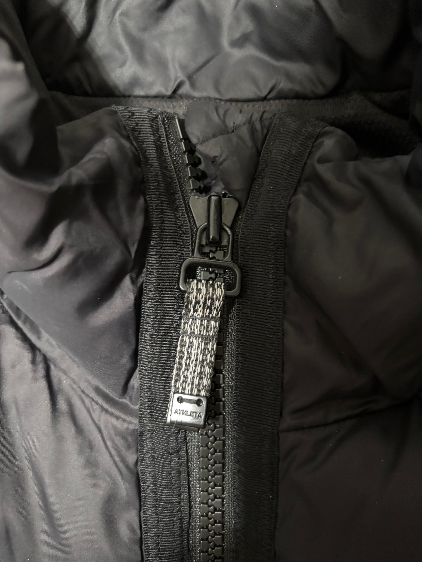 Close up of zipper hardware, large and durable with tassels