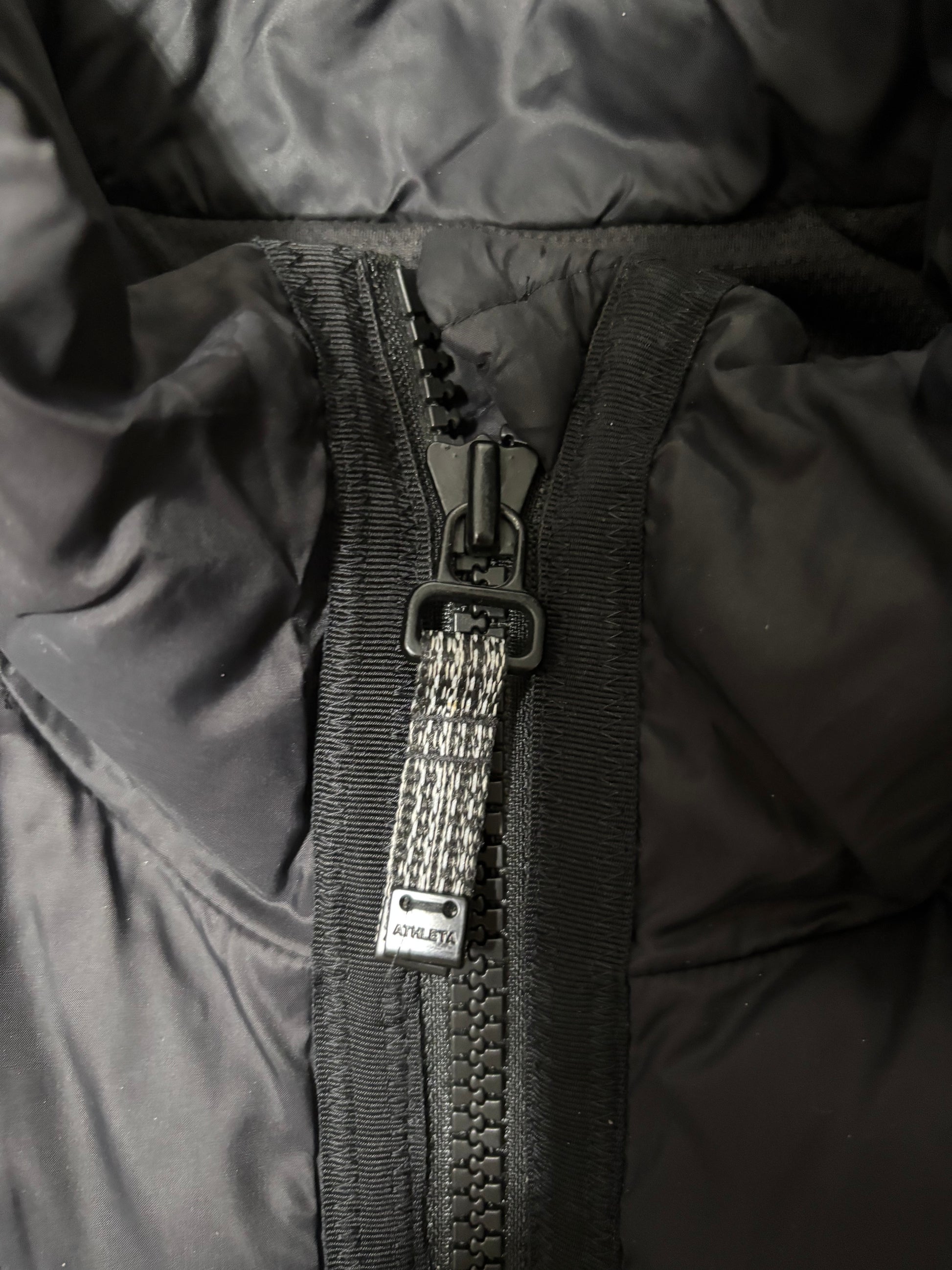 Close up of zipper hardware, large and durable with tassels