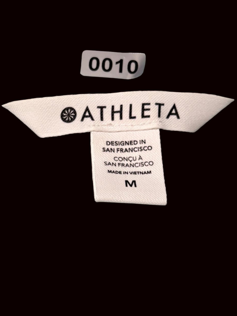 "Athleta Trailbliss t-shirt tag detail showing brand and size information
