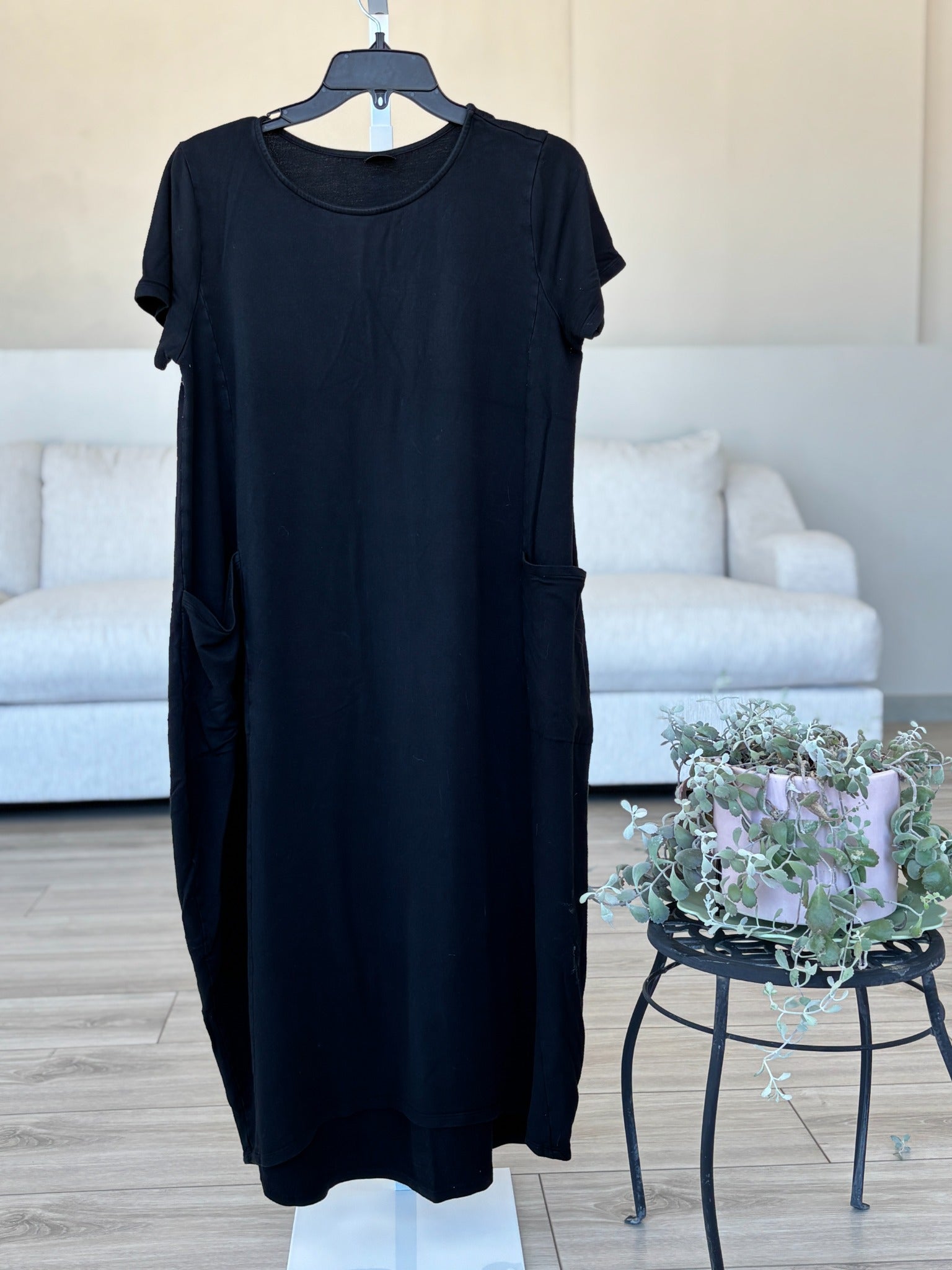 Black medium dress with round neckline short sleeves and cocoon style hem