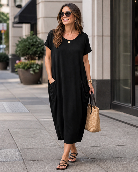 Black short sleeve slouch pocket dress with relaxed draped silhouette