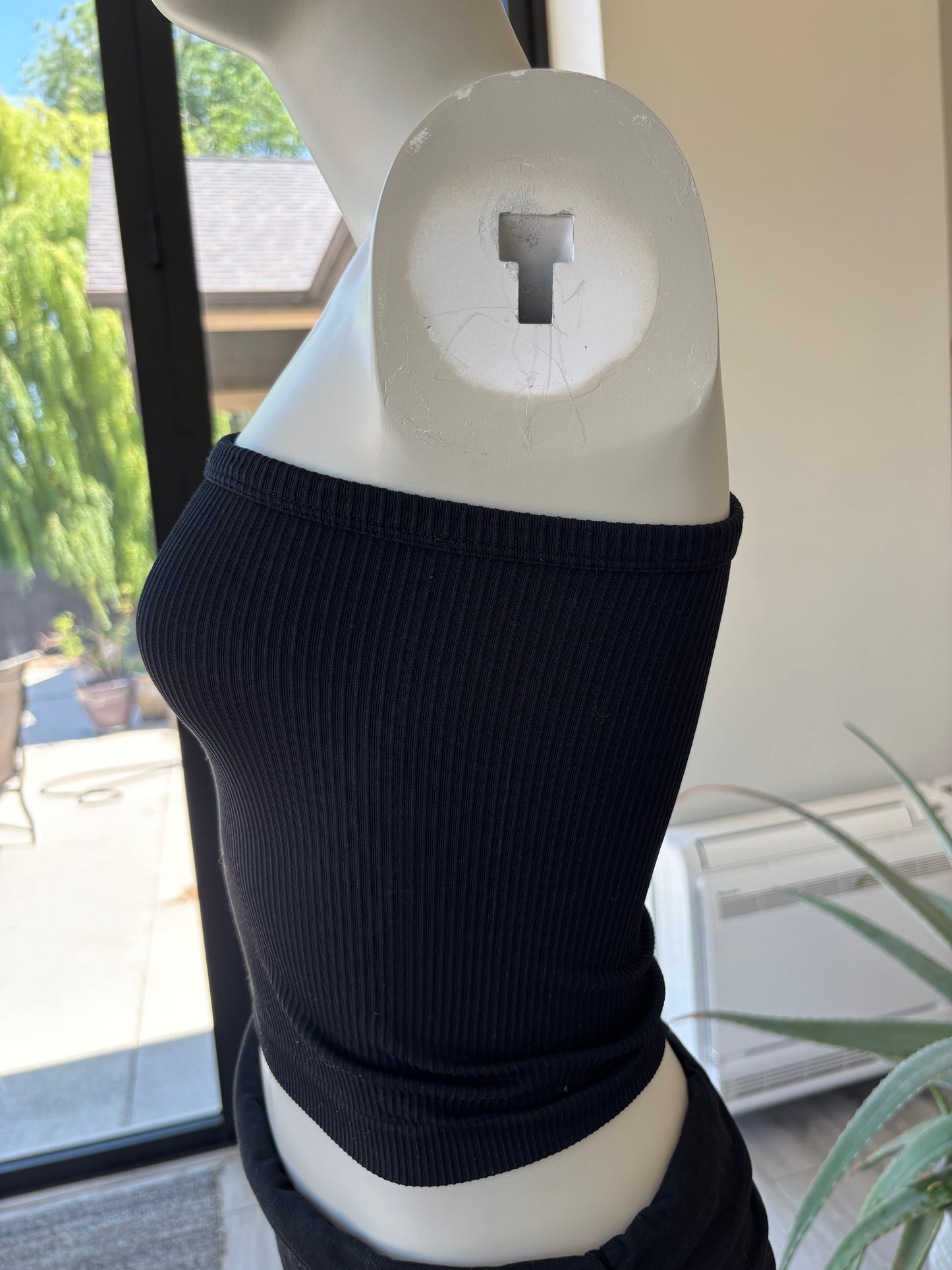 Black ribbed Fornia crop tank with asymmetrical neckline and modern fitted style