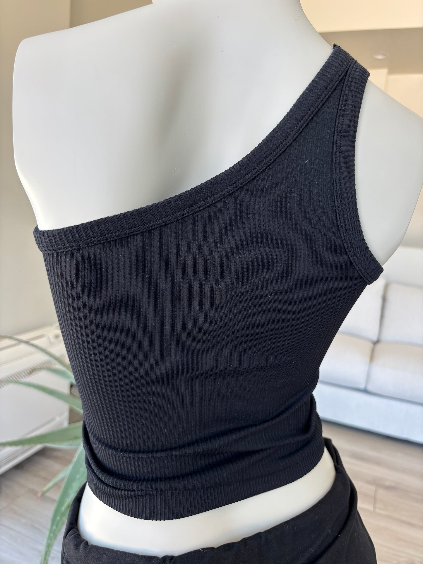 Fornia black sleeveless one-shoulder top styled for elevated casual wear