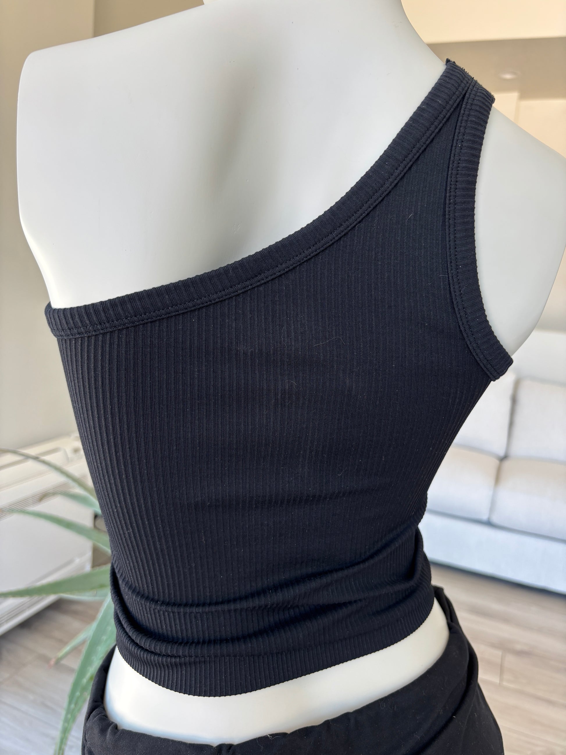 Fornia black sleeveless one-shoulder top styled for elevated casual wear