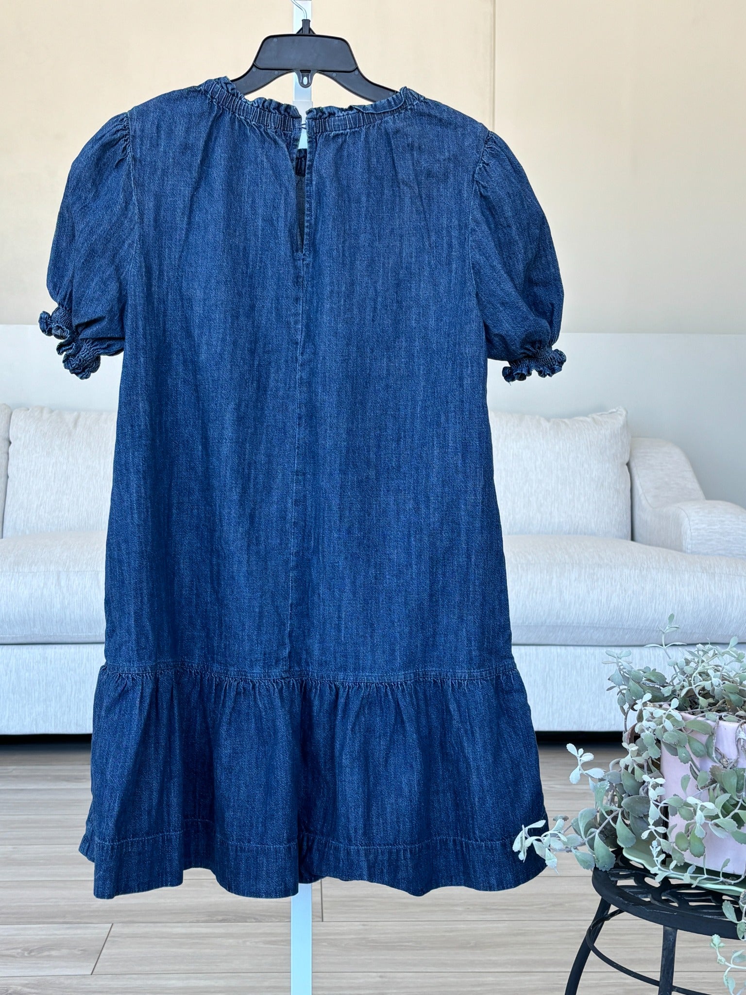 Medium blue chambray denim dress with smocked sleeve cuffs and ruffle hem