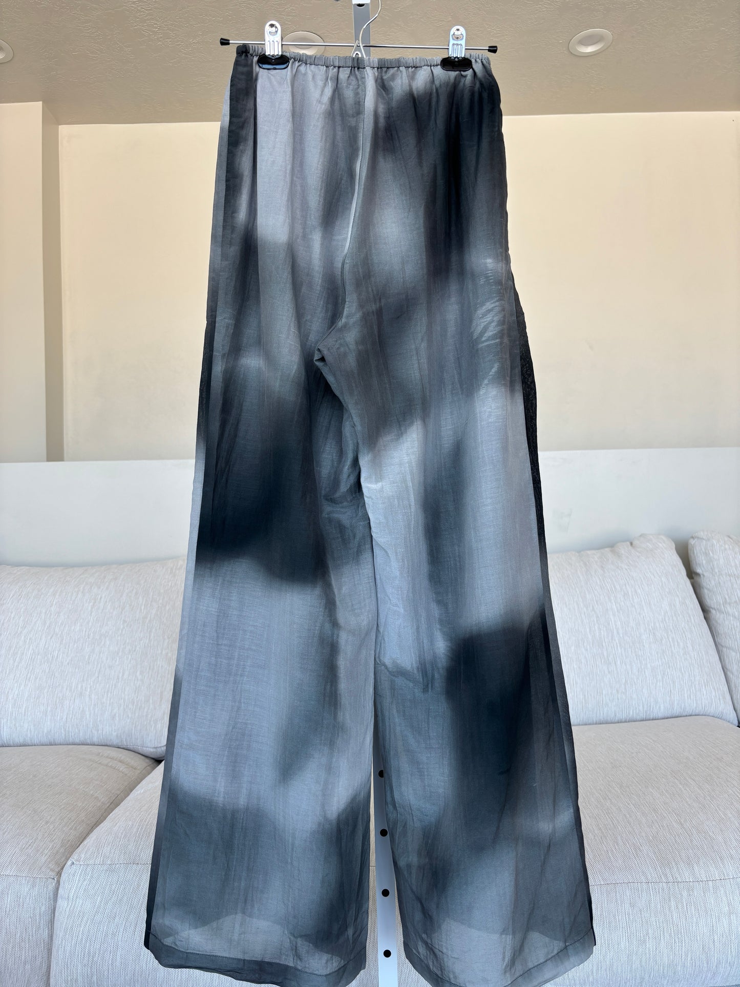 Black and gray DISSH drawstring lounge pants with a narrow elastic waist and flowing wide legs.