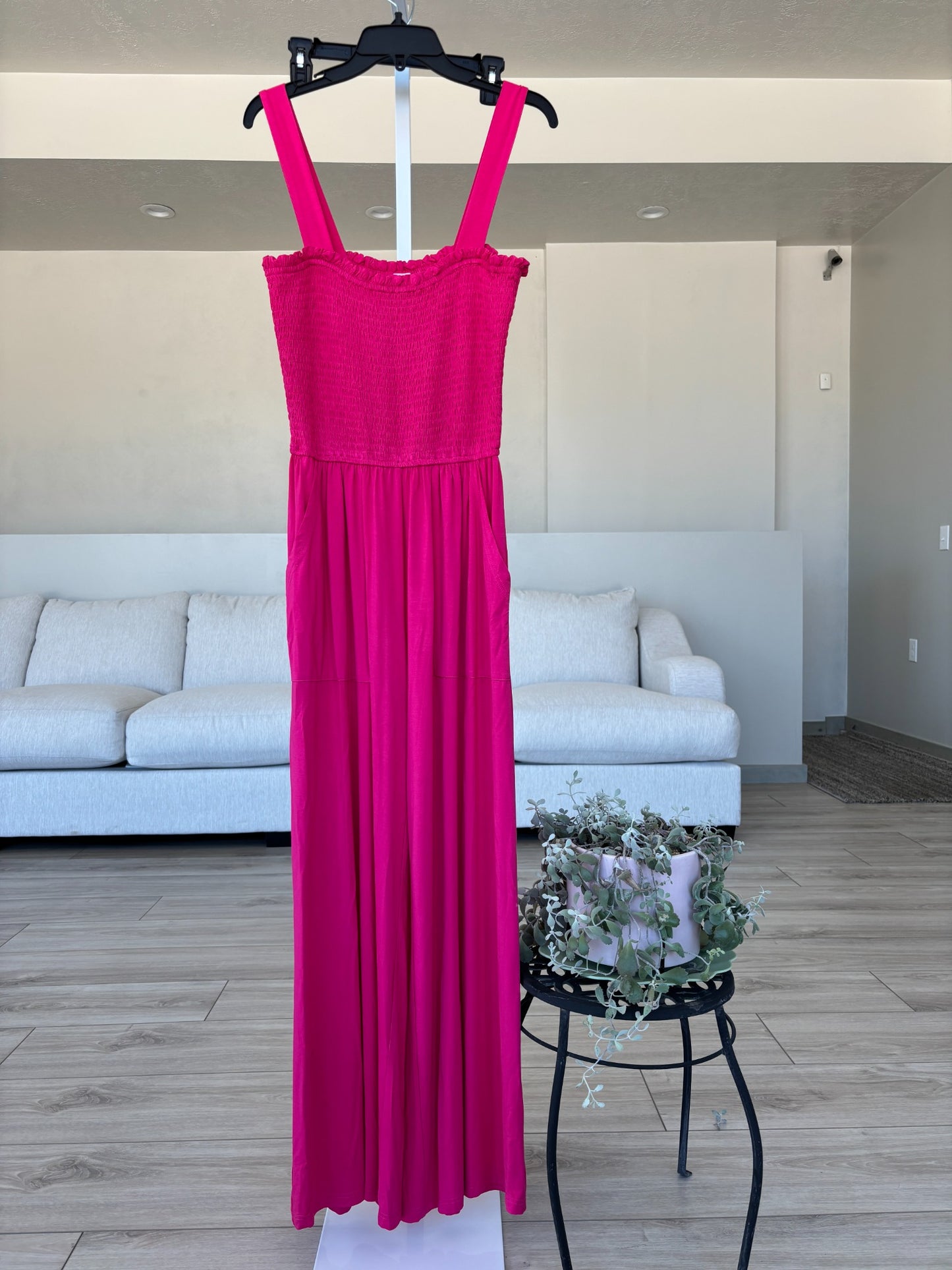 Fuchsia sleeveless jumpsuit with smocked top and relaxed summer vacation style