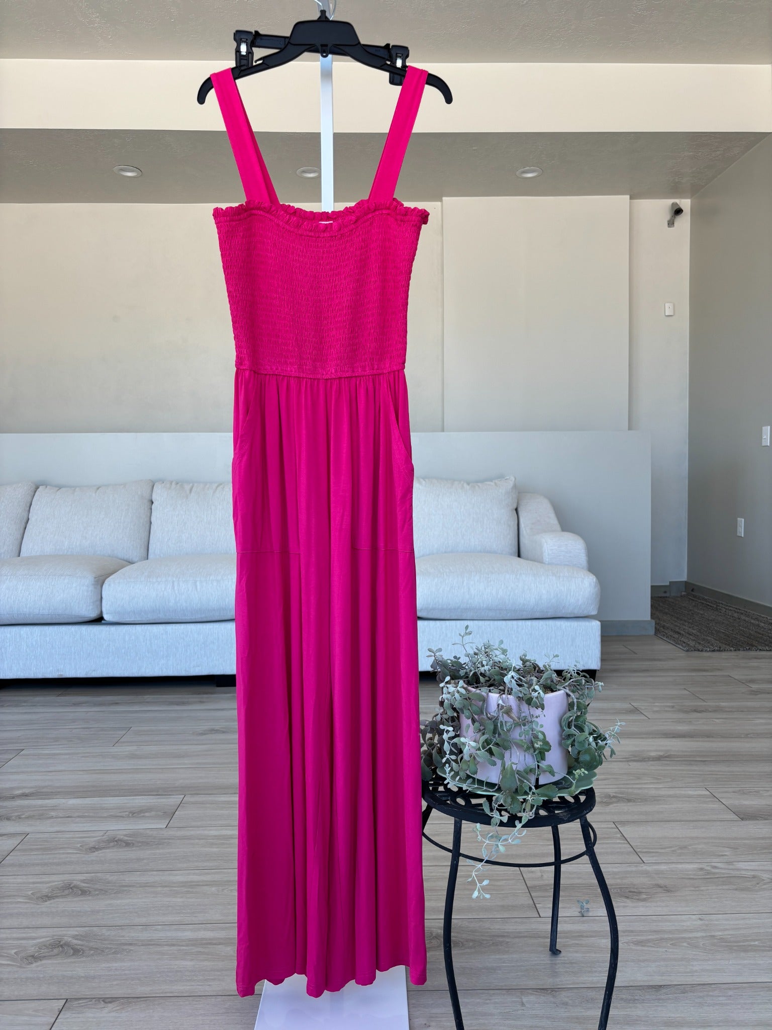 Fuchsia sleeveless jumpsuit with smocked top and relaxed summer vacation style