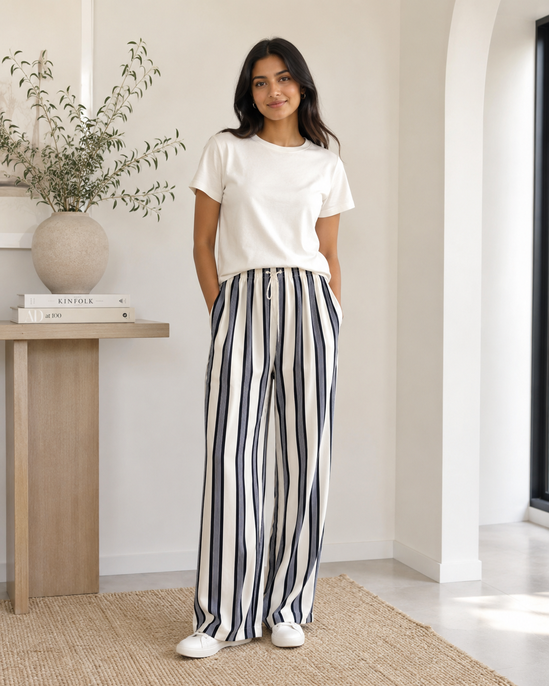 Off-white and dark navy H&M pull-on pants with bold vertical stripes, a satin finish, and wide-leg silhouette.