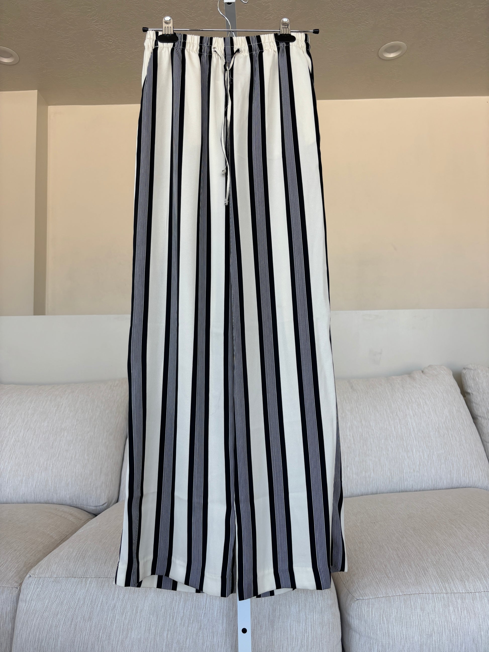 H&M wide-leg striped pants made from recycled polyester with a soft sheen and adjustable drawstring waistband.