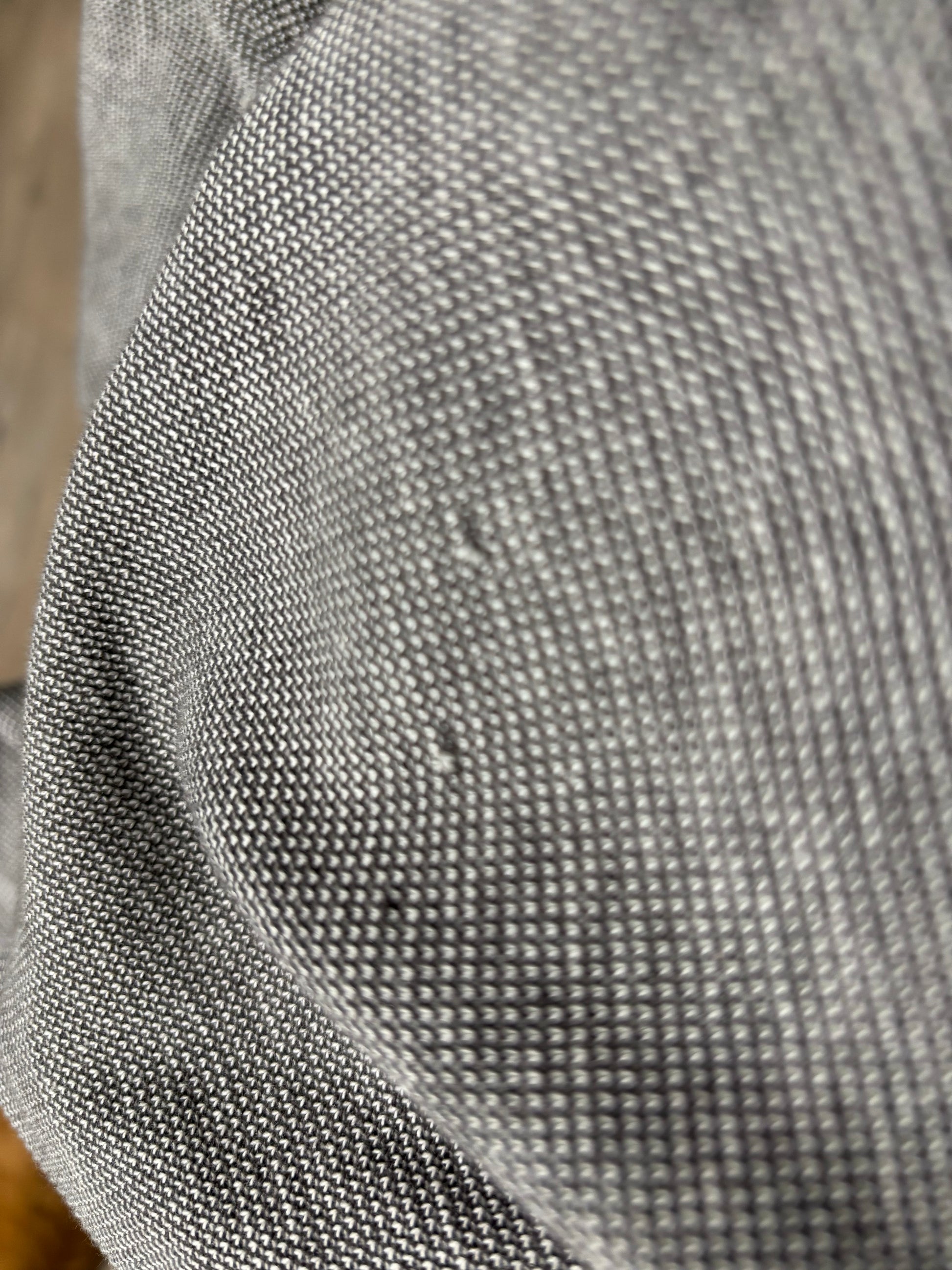 Fabric close-up: Close-up of LinkSoul 100% luxury cotton micro-houndstooth knit fabric texture in gray, showing minor snag detail