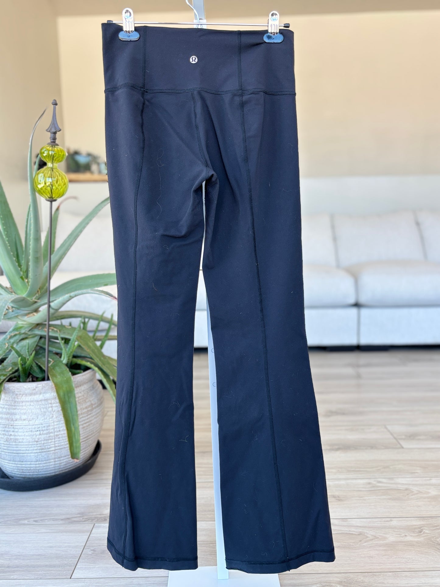 Older style Lululemon black yoga pants with supportive compression and flare leg