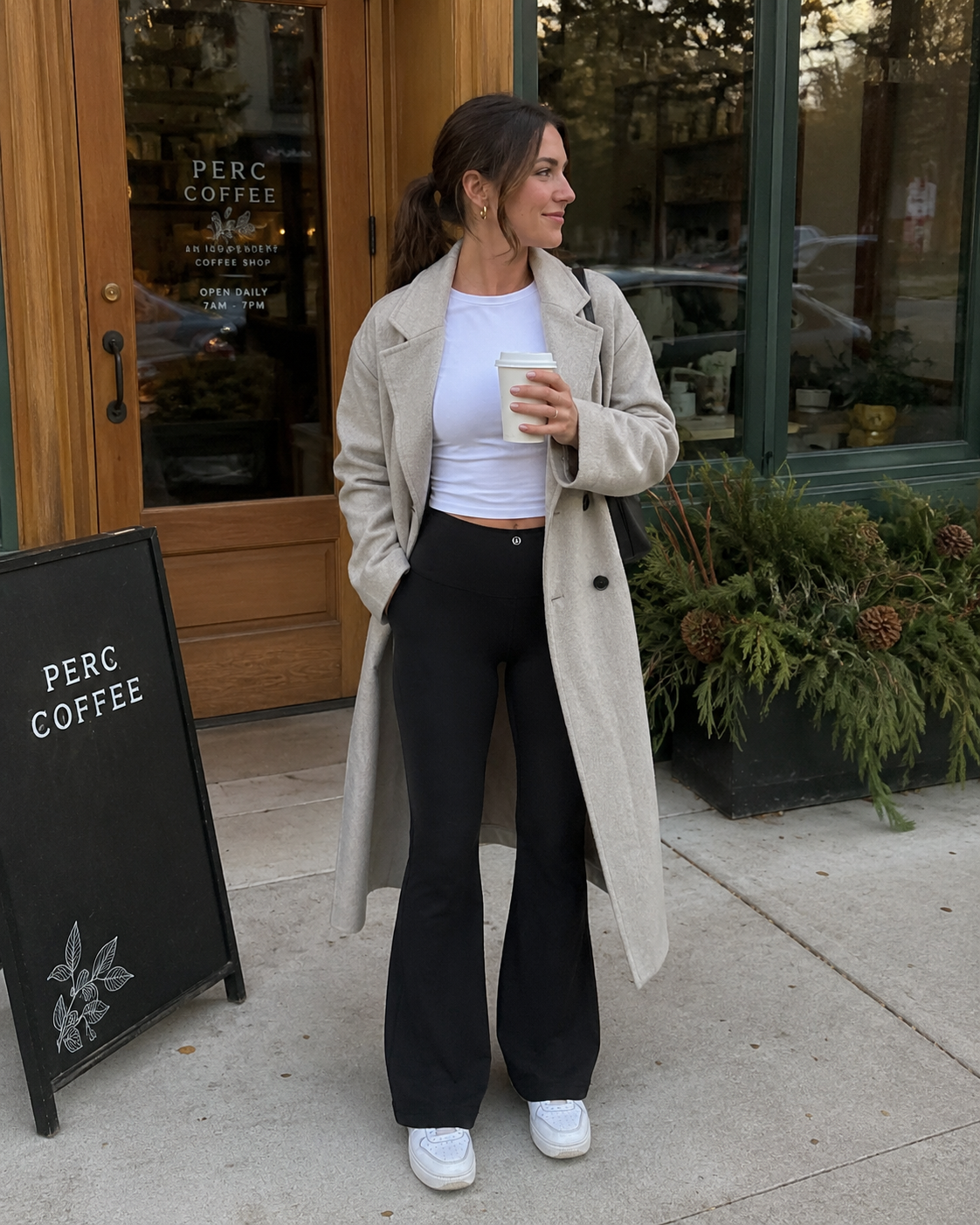 Black Lululemon studio yoga pants with classic flare leg and back logo