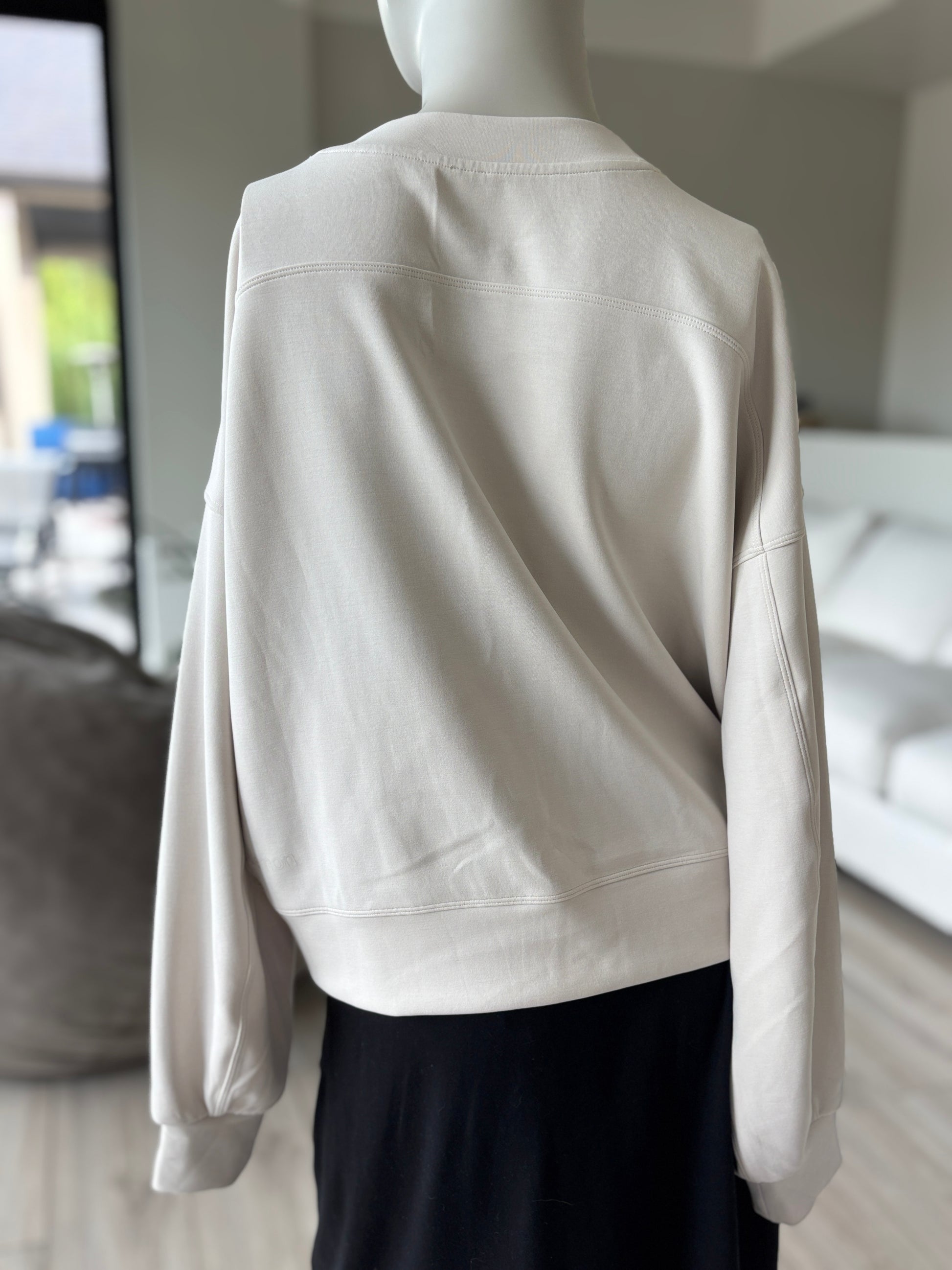 Lululemon light ivory cropped crewneck sweatshirt with long sleeves, dropped shoulders, and a wide banded hem.
