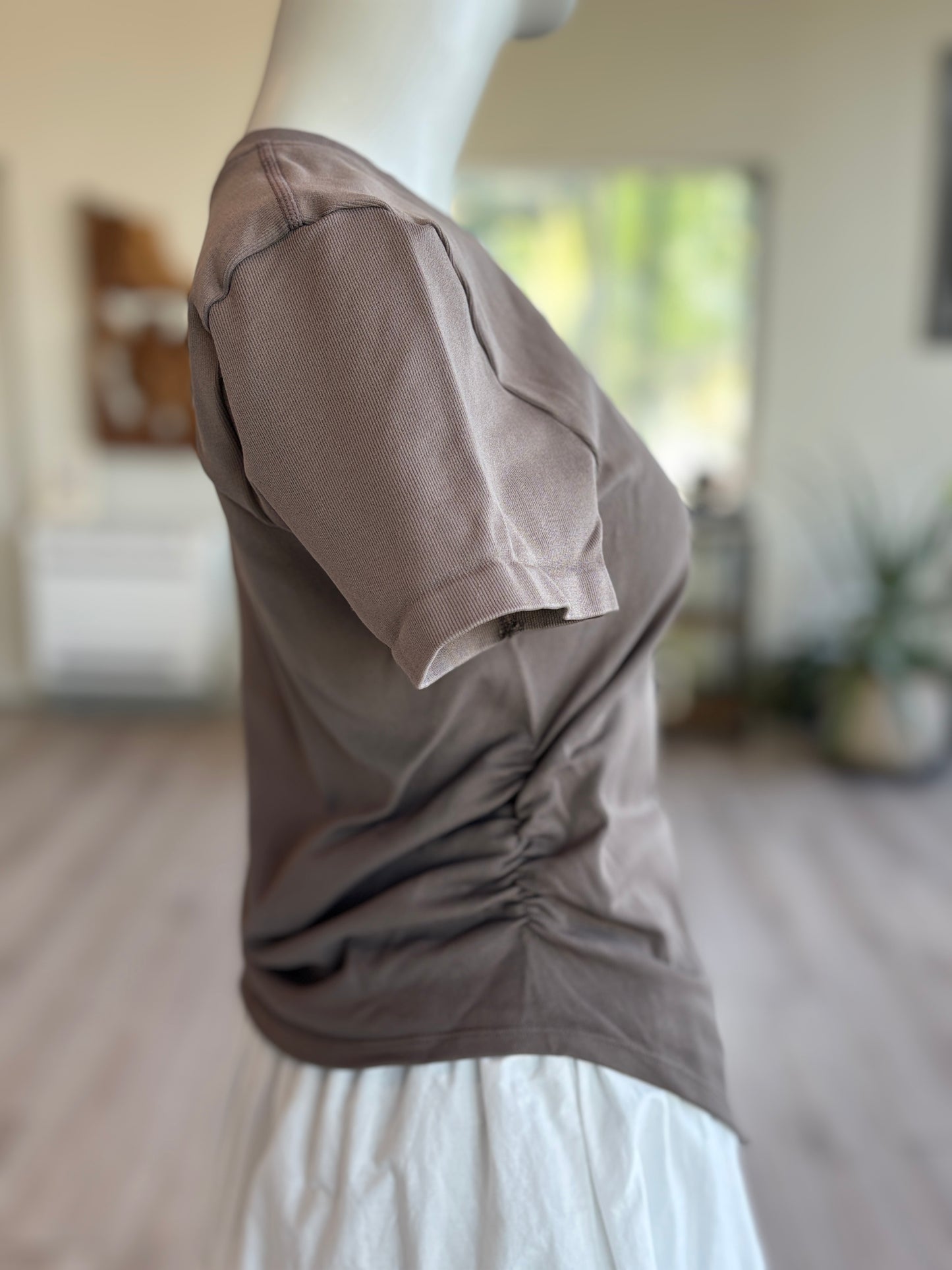 OQQ khaki asymmetrical hem top size large with fitted silhouette and neutral color