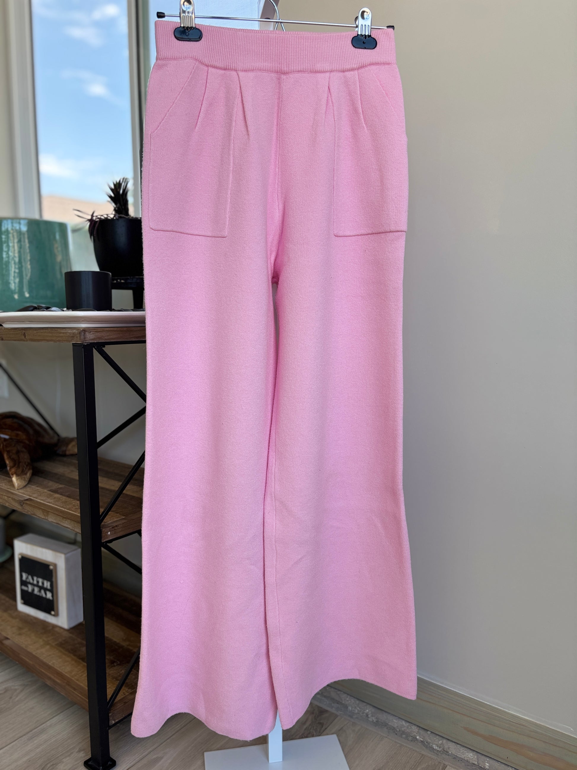 Pink Lily pink wide leg knit pants with square front pockets and elastic waist styled for a feminine lounge look from Adored Again boutique