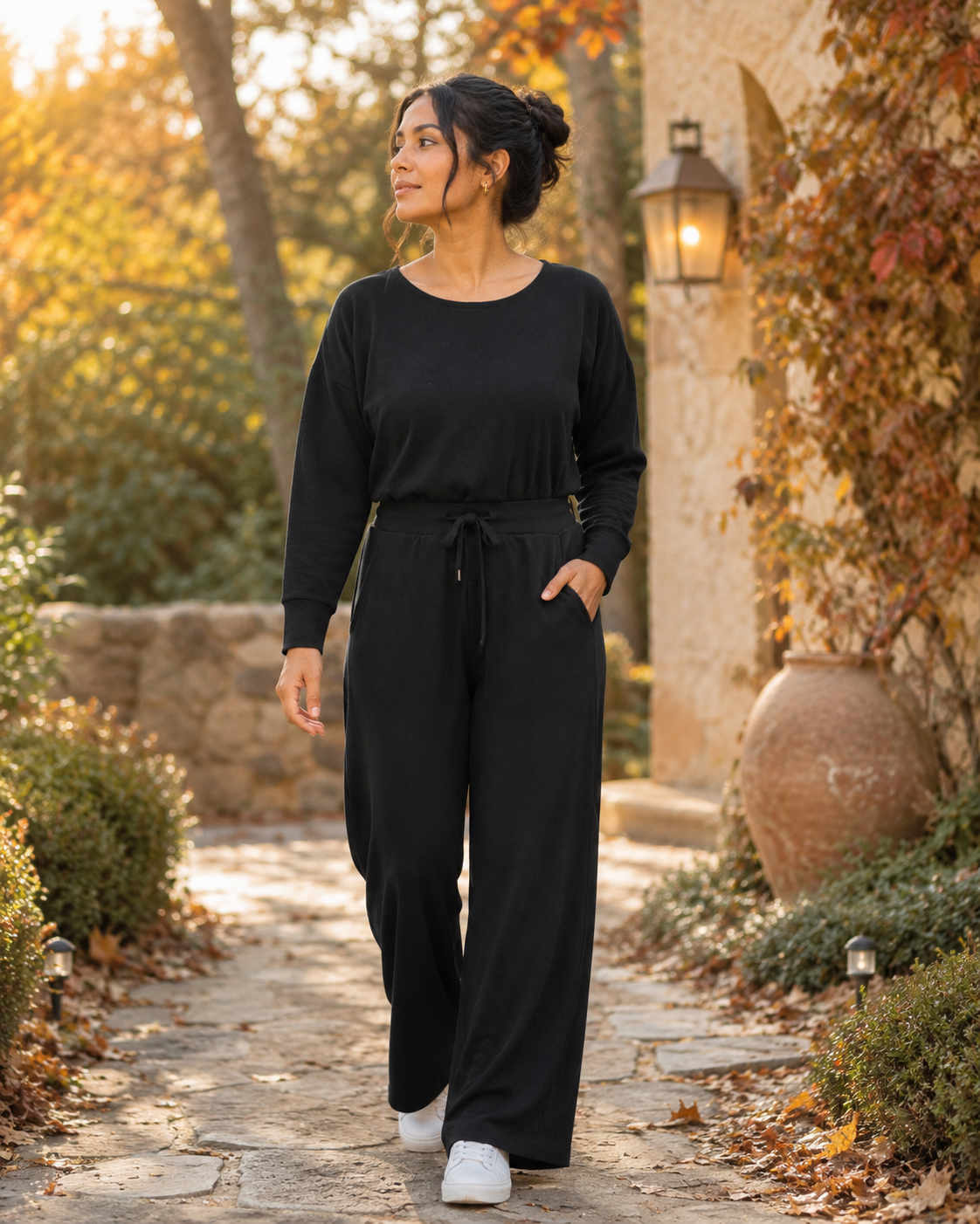 SPANX AirEssentials women’s black long-sleeve wide-leg jumpsuit with boat neckline, defined waist, and pockets in size M.