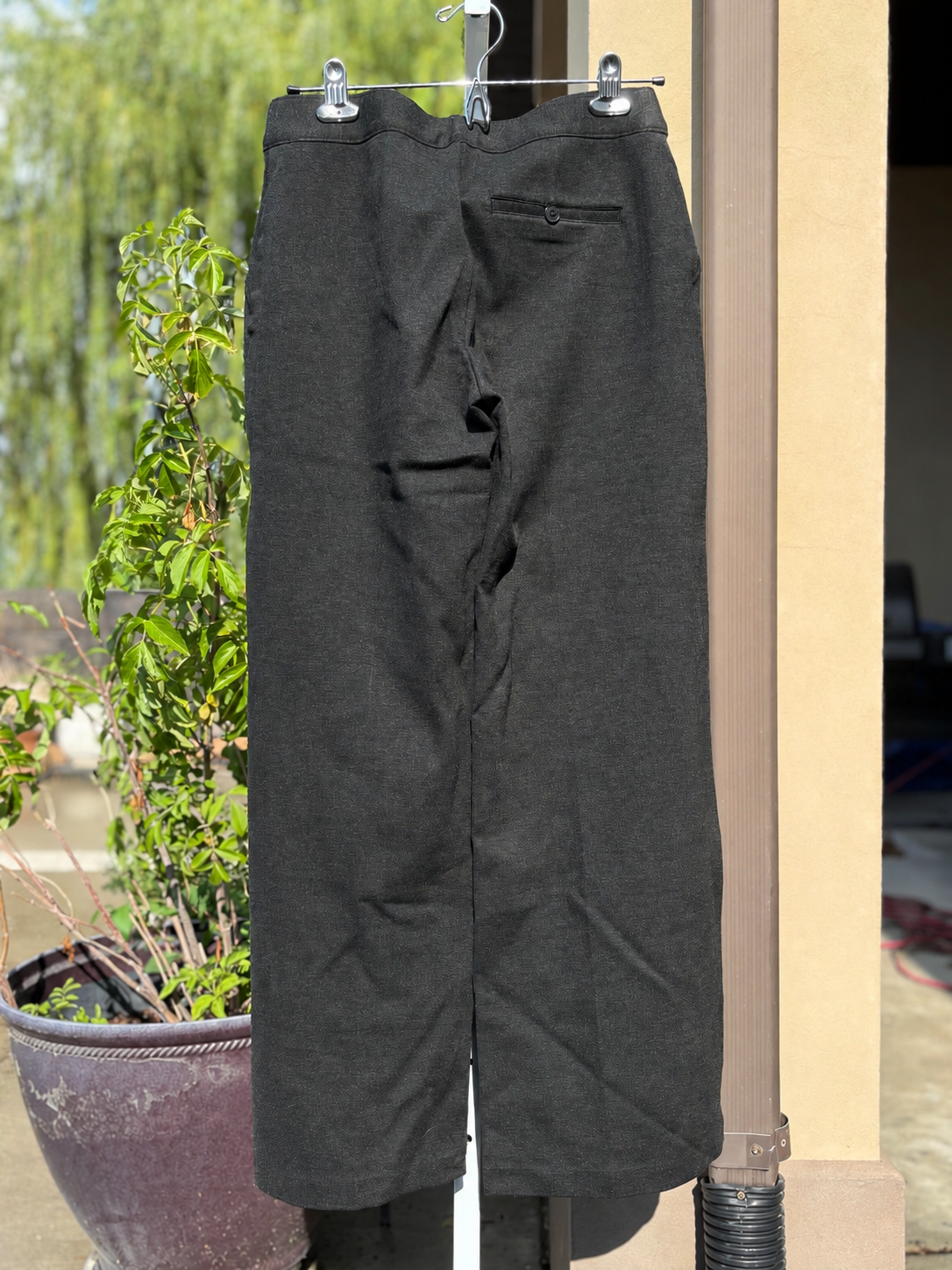 SPANX charcoal gray stretch work pants featuring a tailored wide-leg shape and petite-length fit.