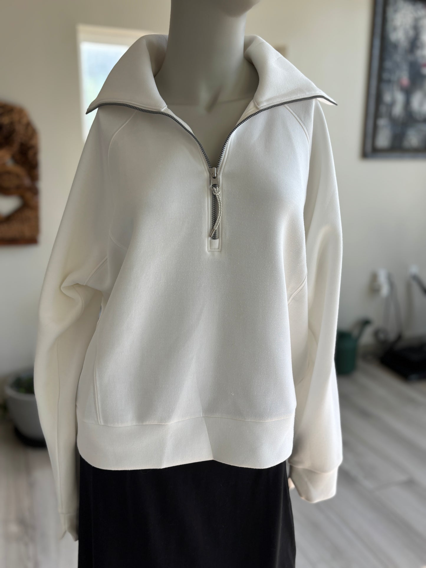 Ivory SPANX shawl-collar sweatshirt featuring a silver half zipper, raglan sleeves, and a wide banded hem in women’s size M.