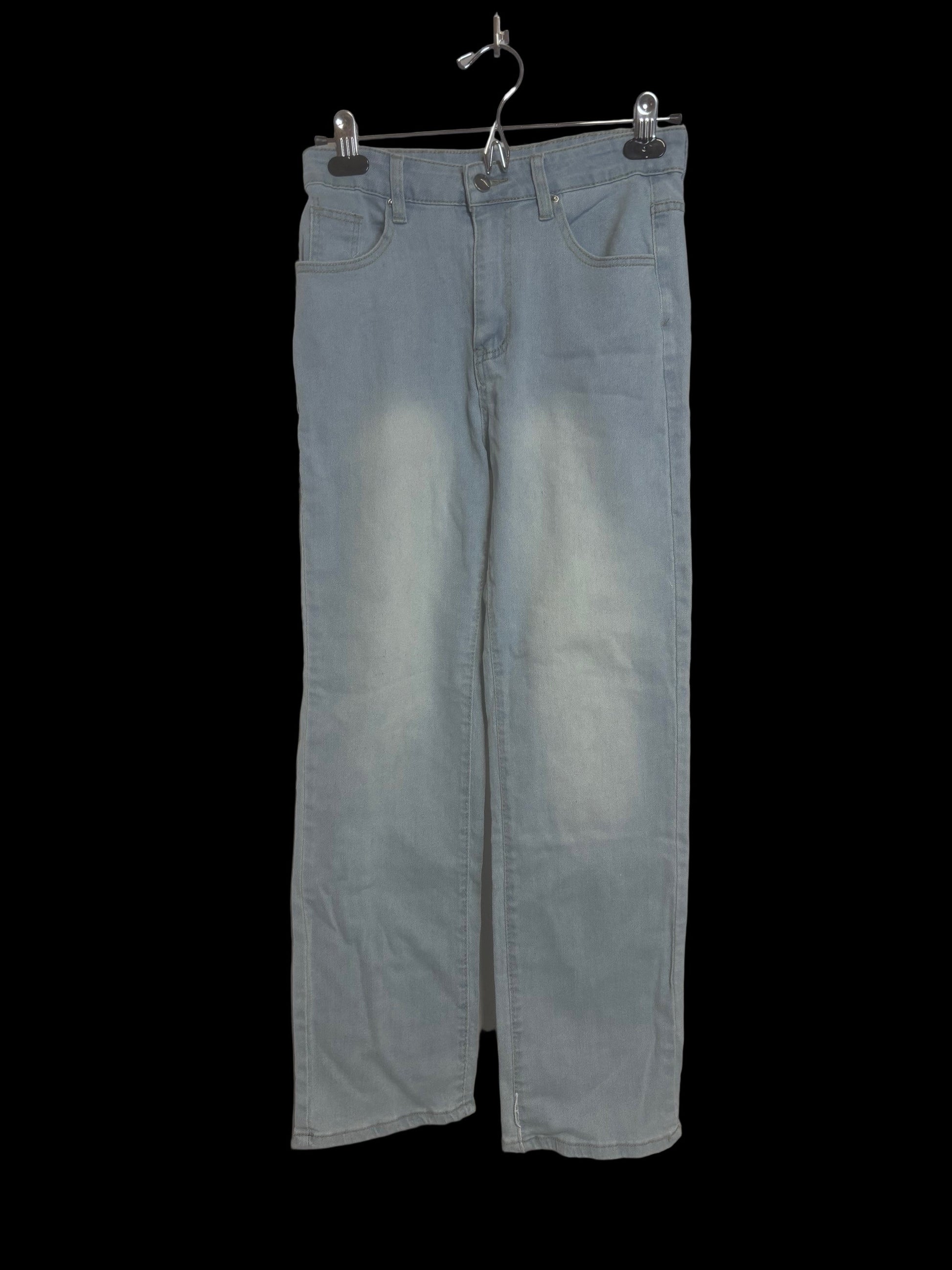 Close-up detail of sky blue jeans showing fabric texture, stitching, and color-lighter thighs & knees