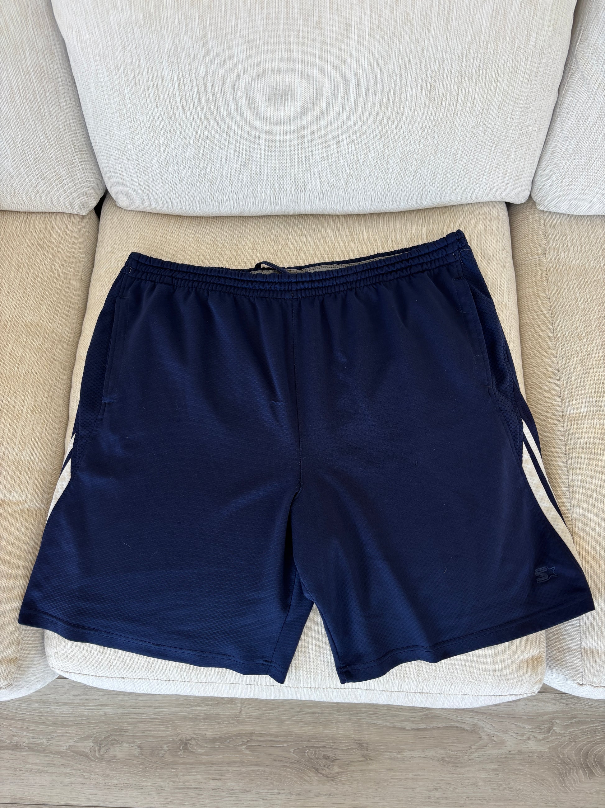 Starter navy athletic shorts with two white stripes and thin gray stripe