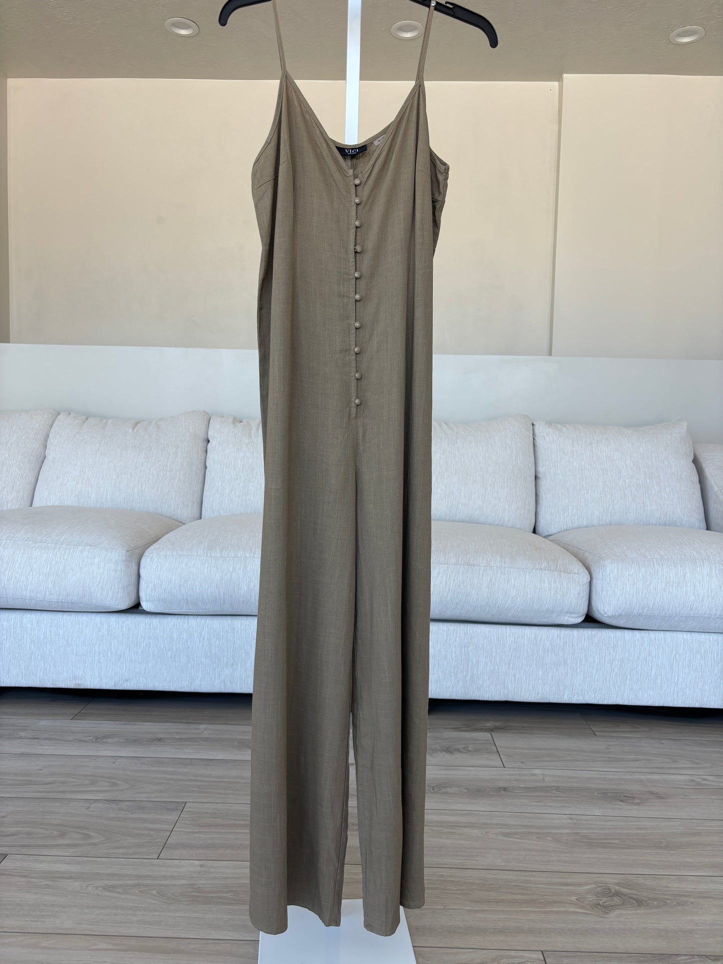 VICI cropped wide leg jumpsuit set styled with a sleeveless front tie vest and clean white tennis shoes.
