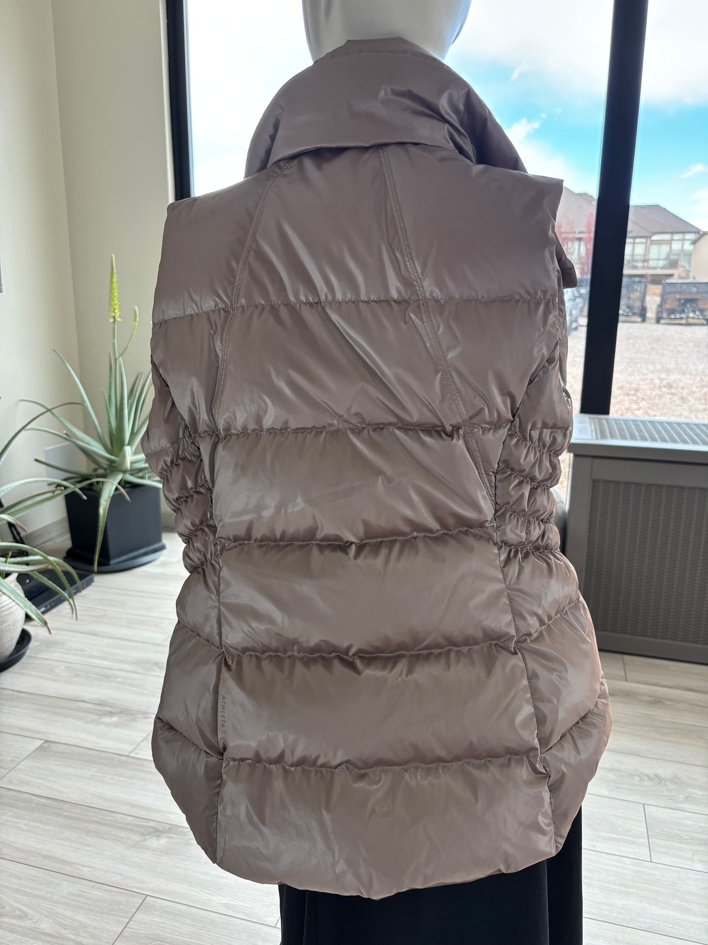 Athleta metallic vest styled with hoodie, knit textures, and warm accessories for winter layering back view