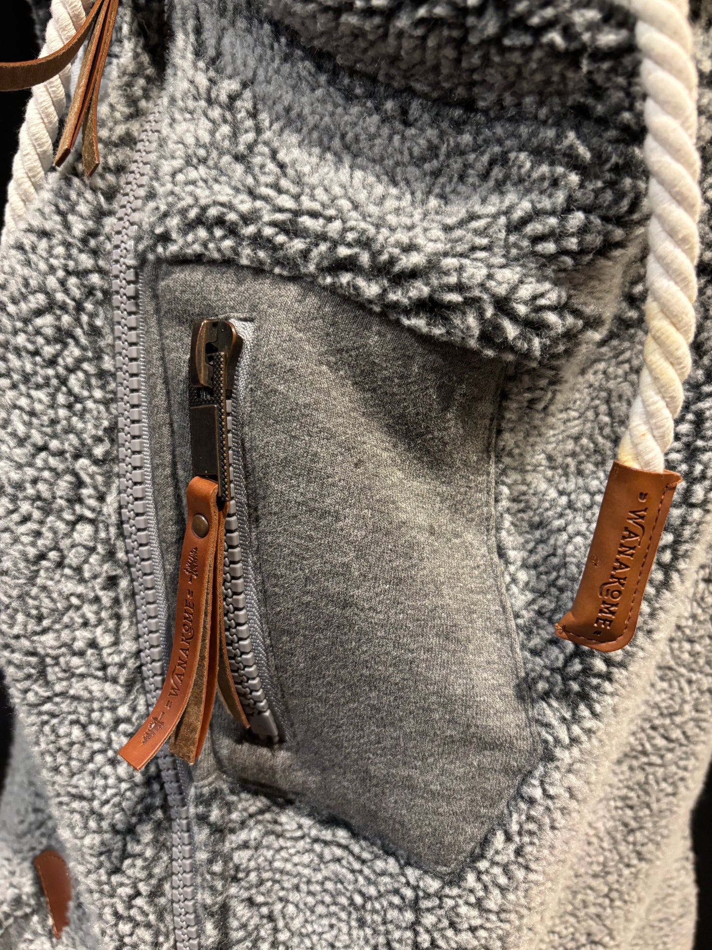 Wanakome sherpa vest close up, leather tassles side pocket, high end