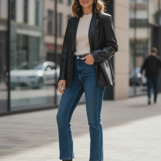 H&M Black vegan leather single breasted jacket.  girl feeling playful in her life.  happy and confident.